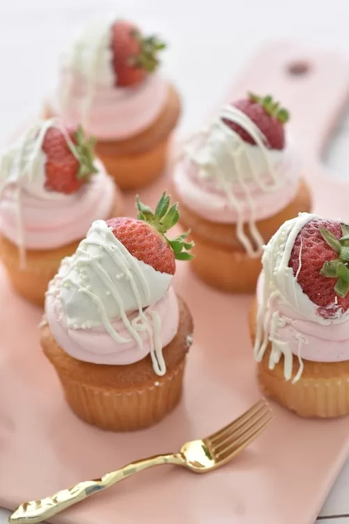 frosted topping cupcakes